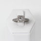 Anillo Solitario, Oro Blanco 14k con Diamantes Laterales y Halo. Diamante Central Corte Princesa